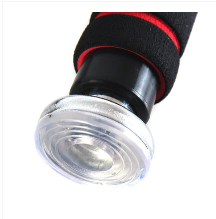 Close-up of a flashlight with a black and red handle on a white background